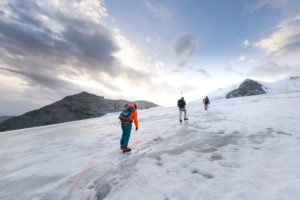 Mountaineer on the way to the Bishorn summit, roped for safety on the glacier Mountaineer on the way to the Bishorn summit, roped for safety on the glacier